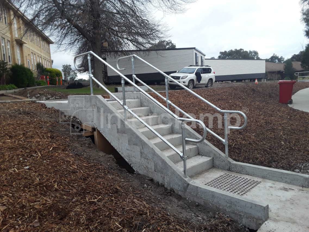 Versatile Interclamp Assist range used to construct a secure handrail system along stairs, ensuring stability and compliance with AS 1428.1-2009 for Australian standards.